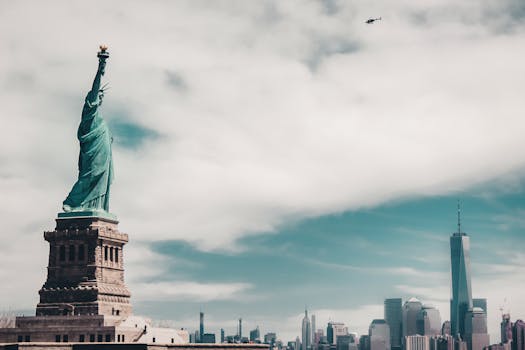 Iconic view of the Statue of Liberty with Manhattan skyline in the background, NYC.