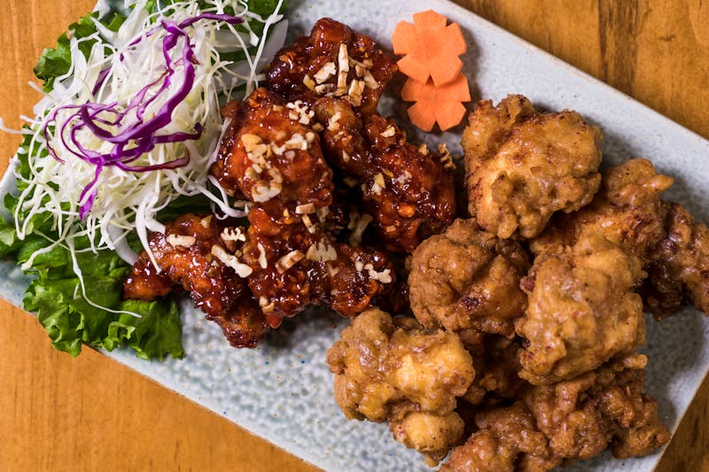 Korean fried chicken platter with garnishes