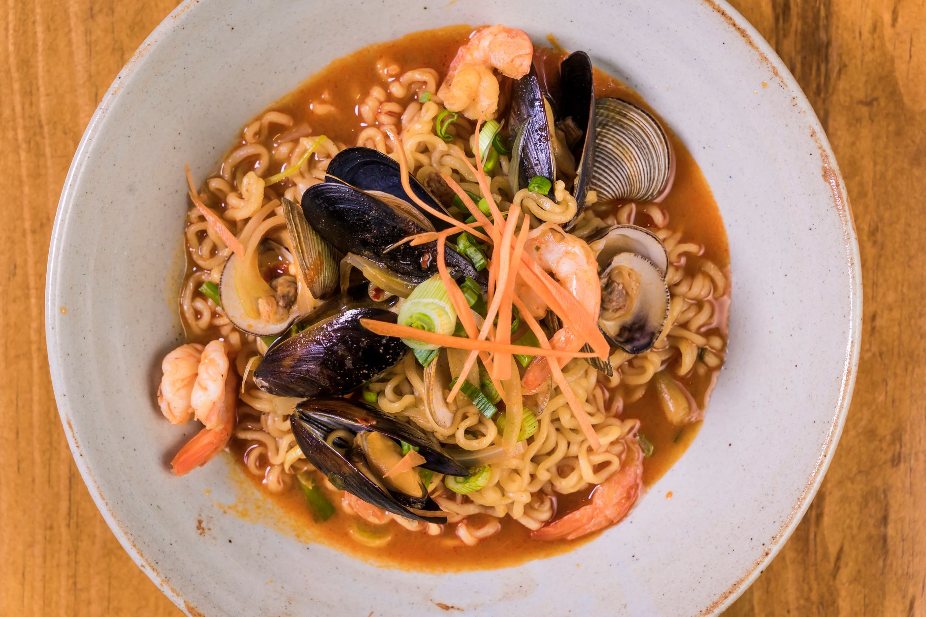 Mussels Clams and Shrimp in Spicy Broth served in bowls with bread