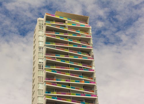 Concrete Building Under White Clouds