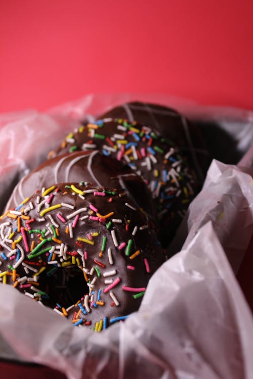 Close-Up Shot of Chocolate Coated Donuts with Sprinkles