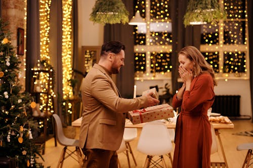 Free Man Giving Christmas Presents to His Wife Stock Photo
