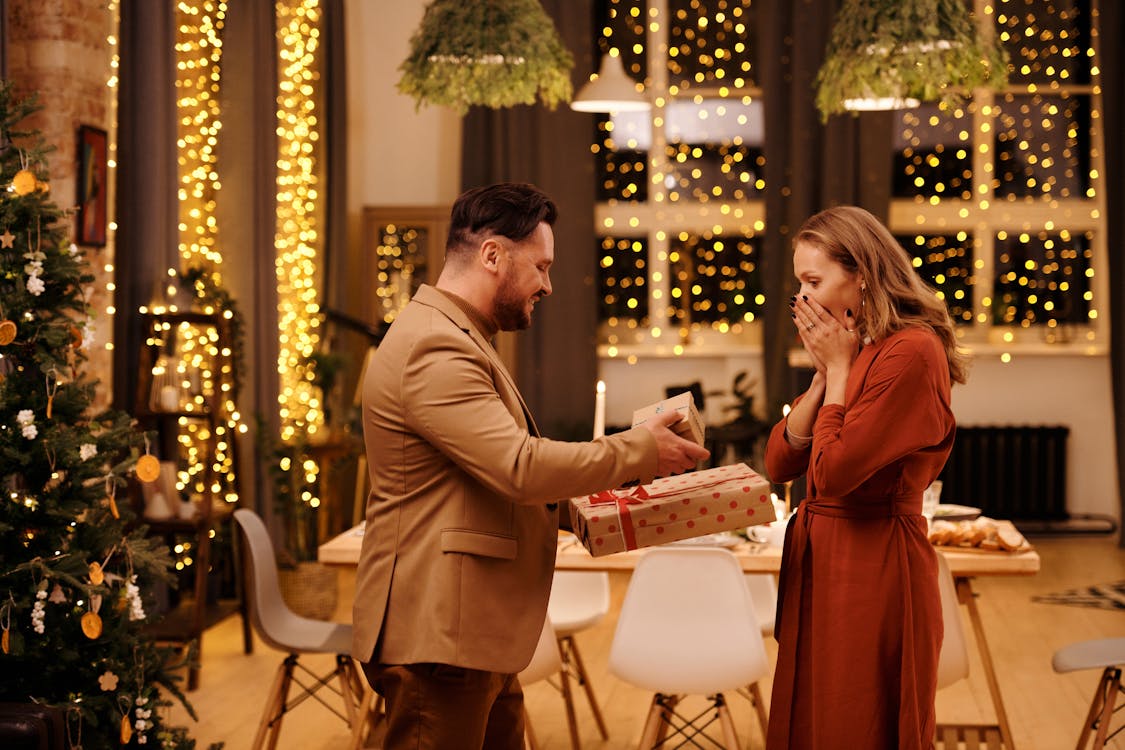 Man Giving Christmas Presents to His Wife