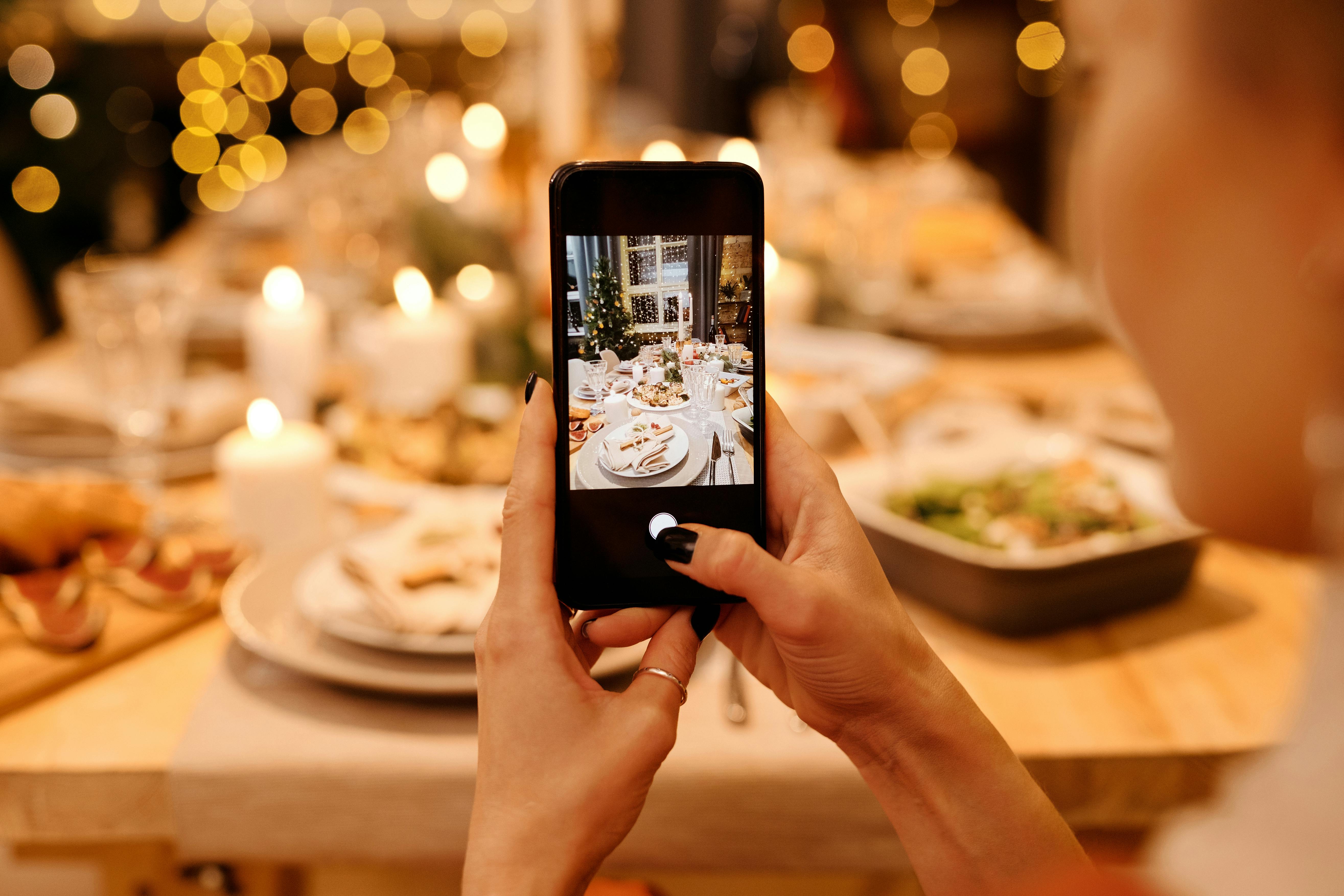 person taking photos using a black smartphone