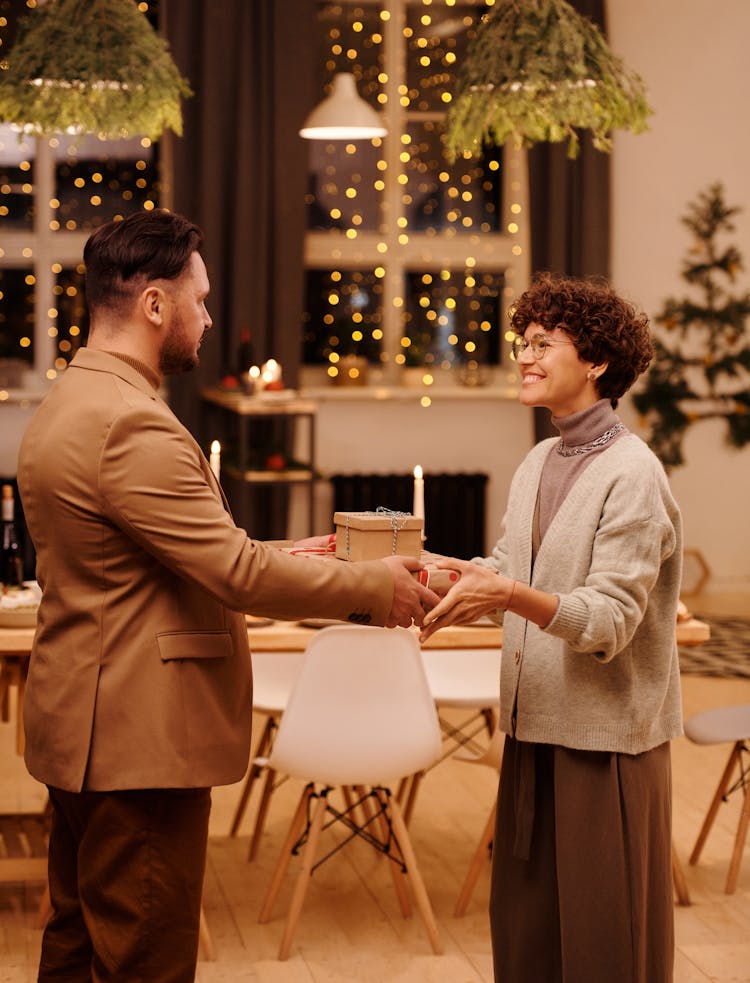 Man Giving Christmas Presents To His Wife