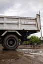 Old truck on dirty road under cloudy sky