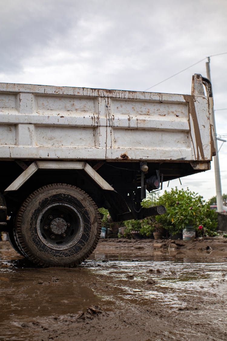 Old Truck On Dirty Road Under Cloudy Sky