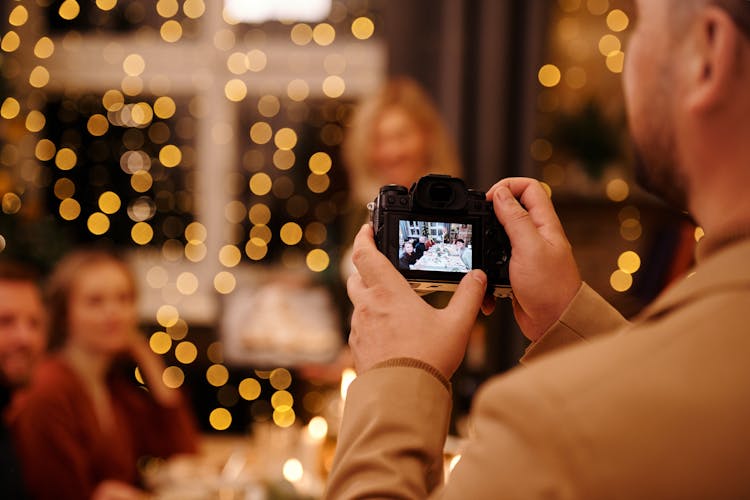 Man Taking Photos Using Black Dslr Camera