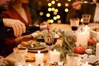 Person Pouring Wine on Glass