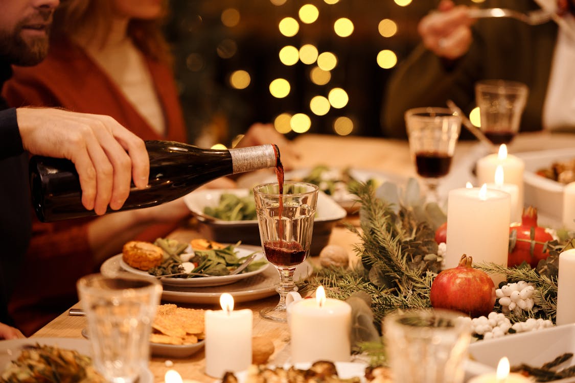 Free Person Pouring Wine on Glass Stock Photo