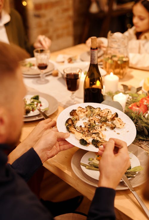 Person Holding White Ceramic Plate With Food