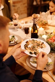 A cozy family dinner with festive decor, delicious food, and holiday atmosphere.