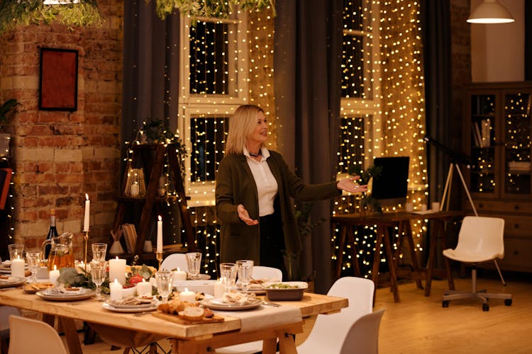 Woman Standing And Waiting Near Dining Table