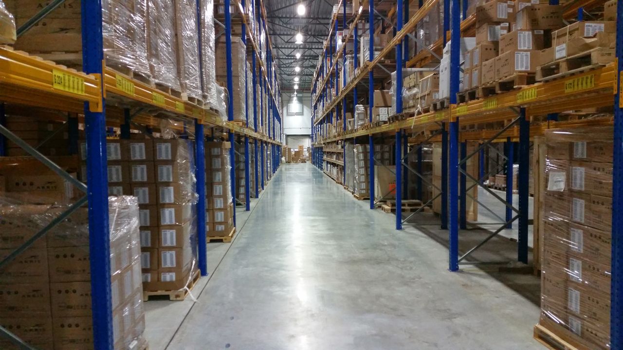 Warehouse aisle with stacked cardboard boxes