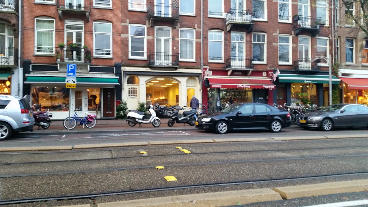 Laptop on a small desk by a window with natural light and minimal decor