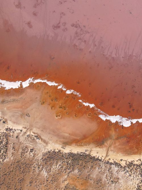 Free Stunning aerial view of Lake Tyrrell's red-hued waters and sandy shoreline in Victoria, Australia. Stock Photo