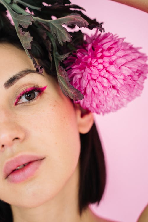 Close-up Photo of Beautiful Woman with Pink Flower 