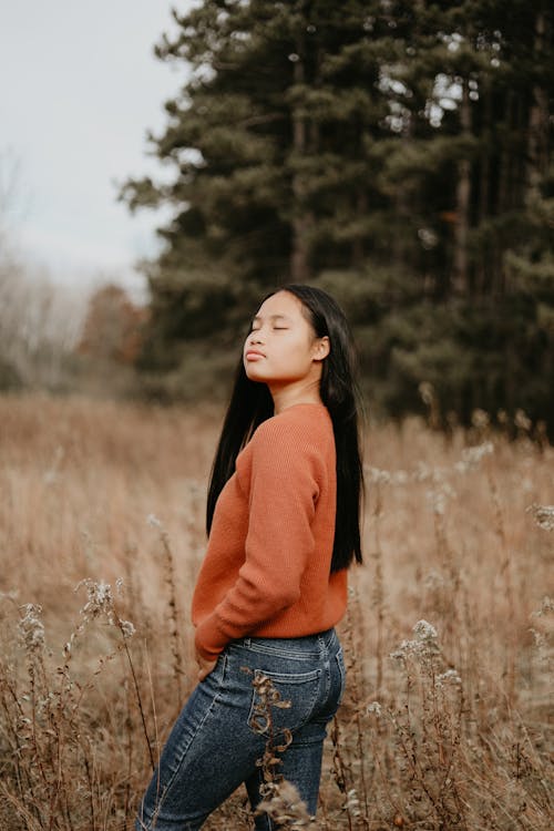 Woman with Eyes Closed Posing on Brown Grass Field