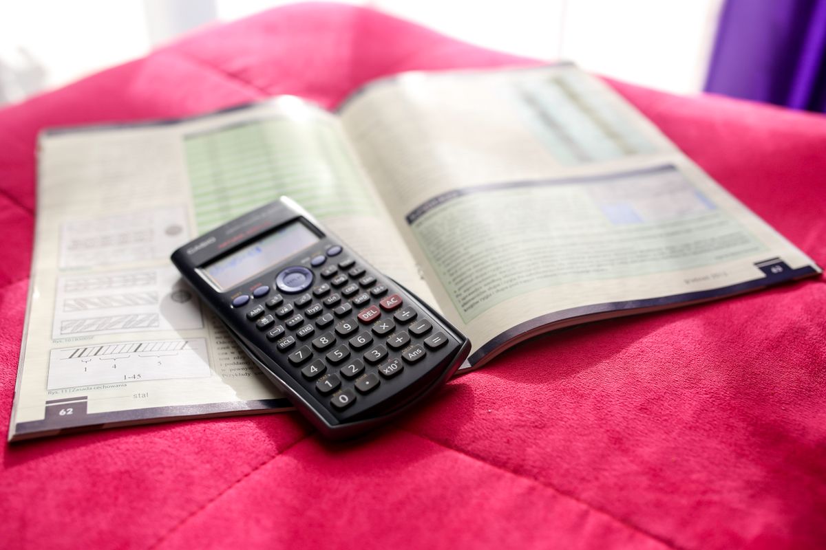 A scientific calculator resting on an open engineering textbook