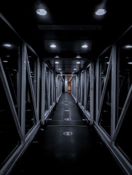 Dramatic night view of an illuminated hallway, blending modern architecture and perspective.