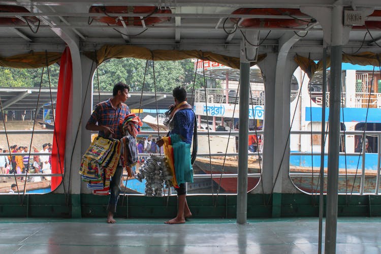 Men Selling Traditional Clothes On Ship