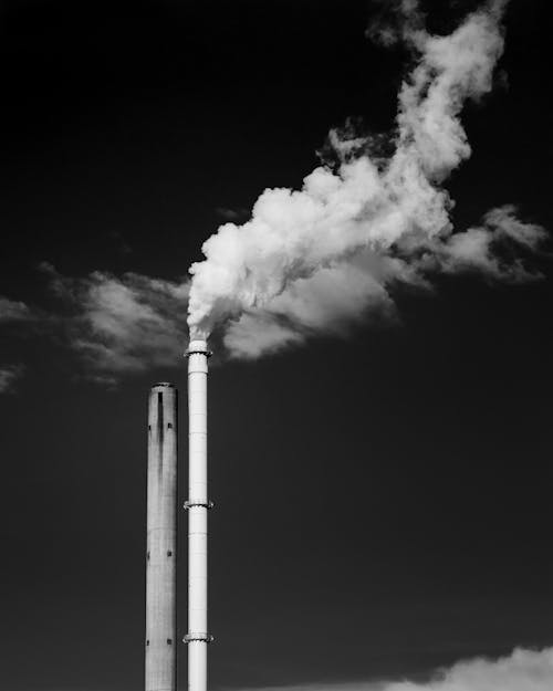 Grayscale Photo of Factory Chimney