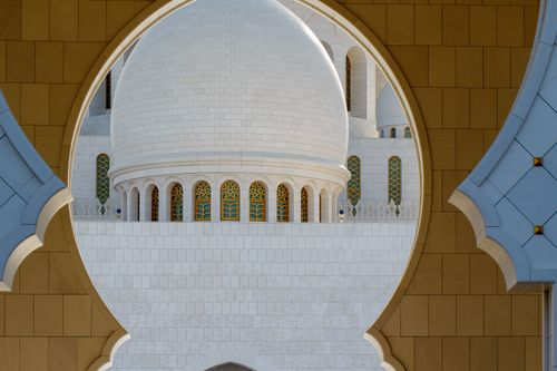 Free View of traditional mosque architecture through decorated archway. Stock Photo