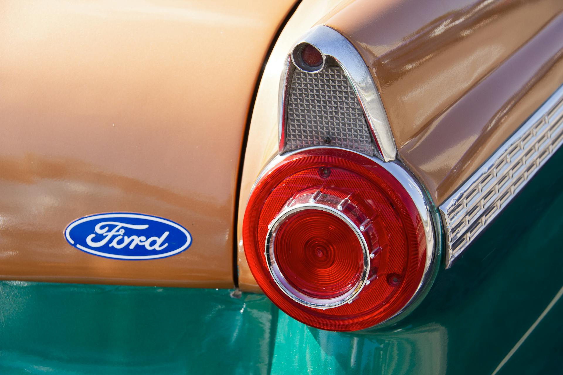 Detailed view of a classic Ford car tail light with chrome and retro design.