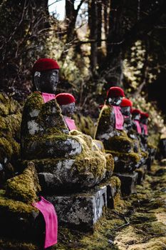 Man in Red and Black Jacket Wearing Red Knit Cap Sitting on Gray Concrete Stairs