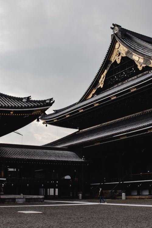 Free Traditional Buddhist temple in Kyoto showcasing intricate roof design against a gray sky. Stock Photo