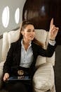 A Woman in Black Blazer Sitting Inside the Airplane