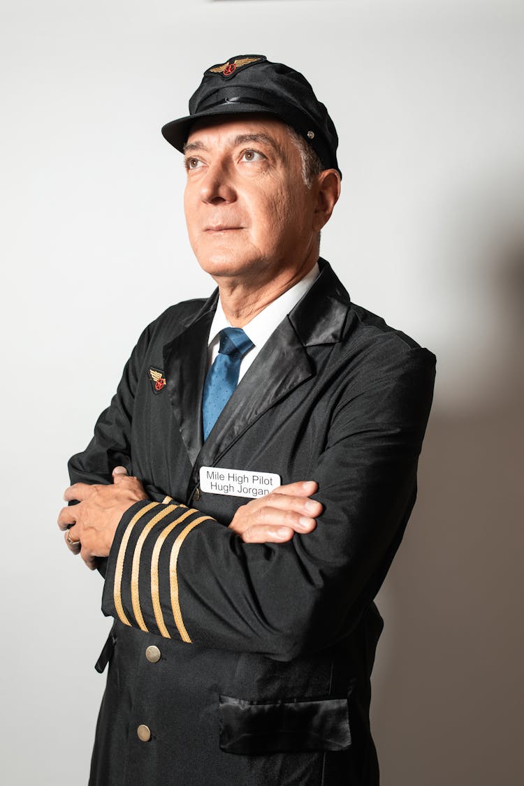 A Pilot Wearing His Uniform While Looking Up