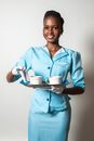 Smiling Woman Holding a Siver Tray with Cups