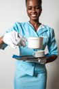 A Flight Attendant Smiling while Holding a Cup of Coffee and a Tray