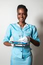 A Smiling Woman Holding a Champagne Glass and a Tray