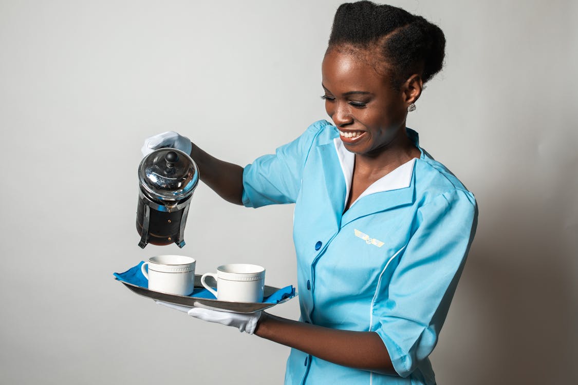 Man in Blue Button Up Shirt Holding Silver Can