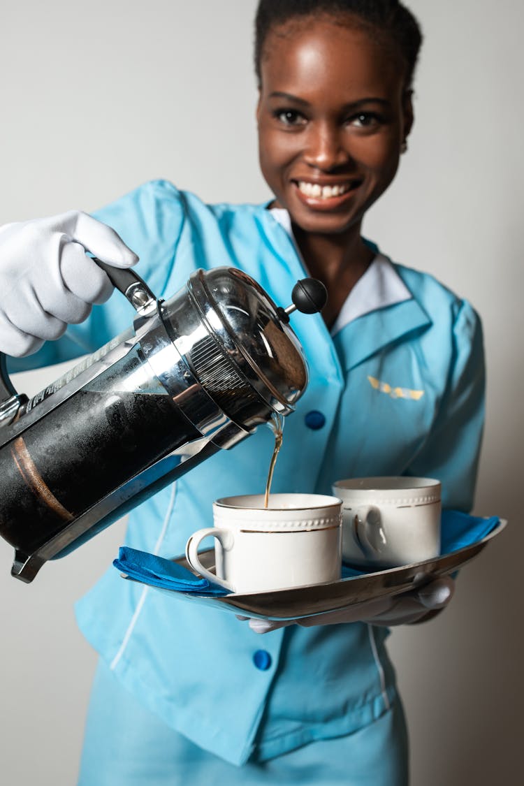 Smiling Woman Pouring Coffee