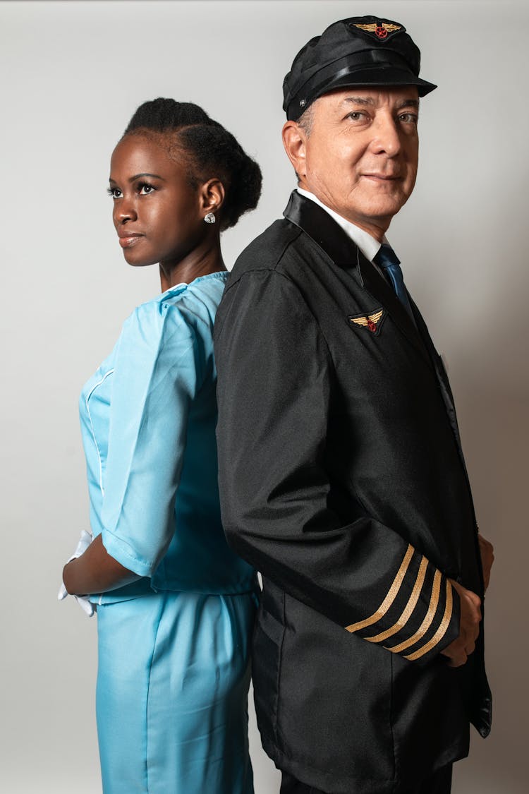 Close-up Photo Of A Pilot Beside A Flight Attendant