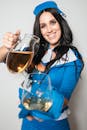 A Stewardess Holding a Pitcher and Glass
