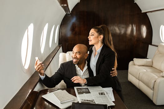 Professional couple enjoying business class comfort on a private jet, sharing a moment.