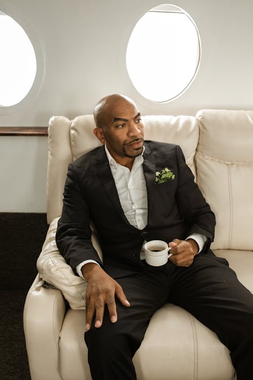 A Man Sitting on Leather Couch