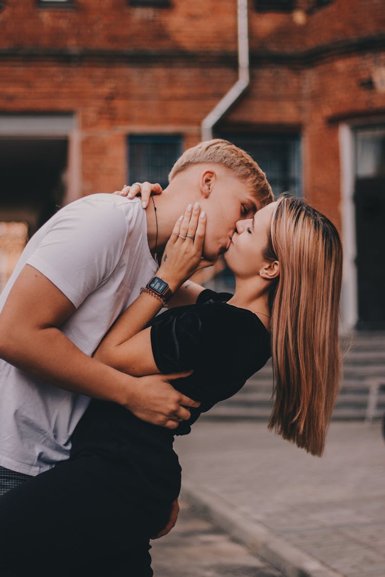 Young Couple Hugging And Kissing Outside