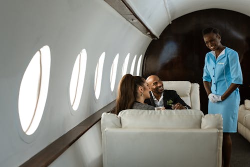 A Flight Attendant Smiling at Passengers in an Airplane