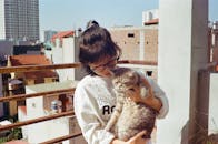 Young Girl Carrying a Cat
