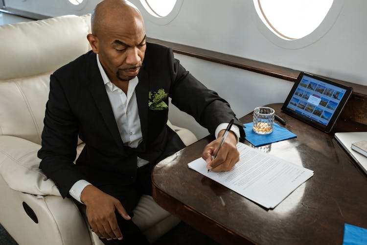 Businessman Signing A Contract On A Private Jet 