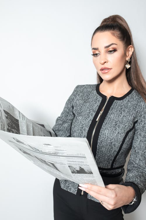 Free Businesswoman looking at a Newspaper Stock Photo