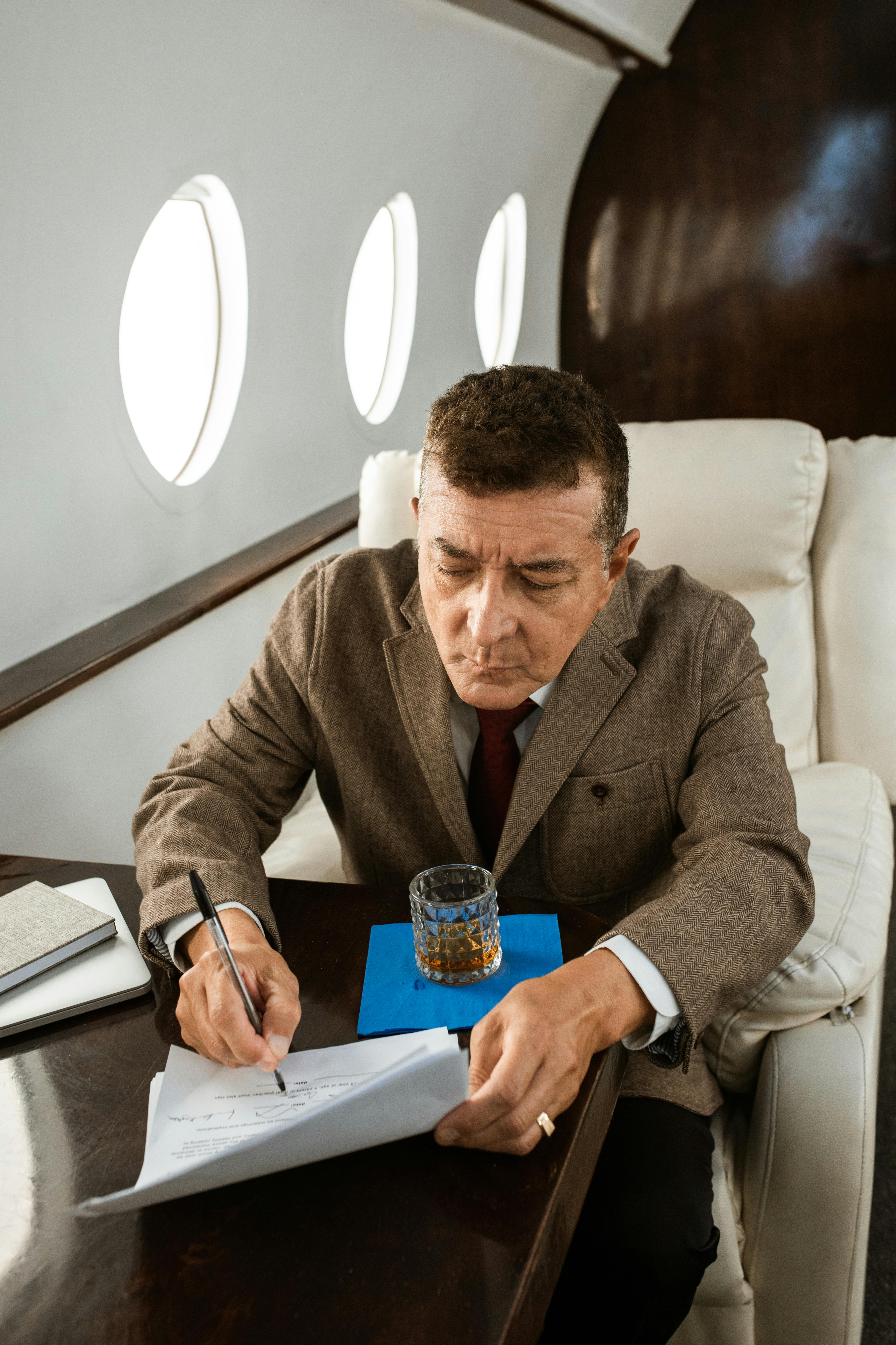 businessman signing a contract on a private jet
