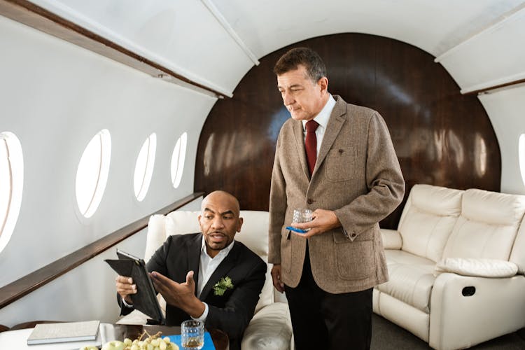 Businessmen Having Discussions On A Private Jet