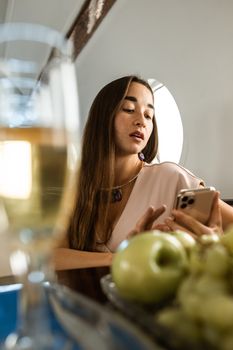 Stylish woman on a luxury private jet with fruits and champagne, reflecting wealth and business elegance.