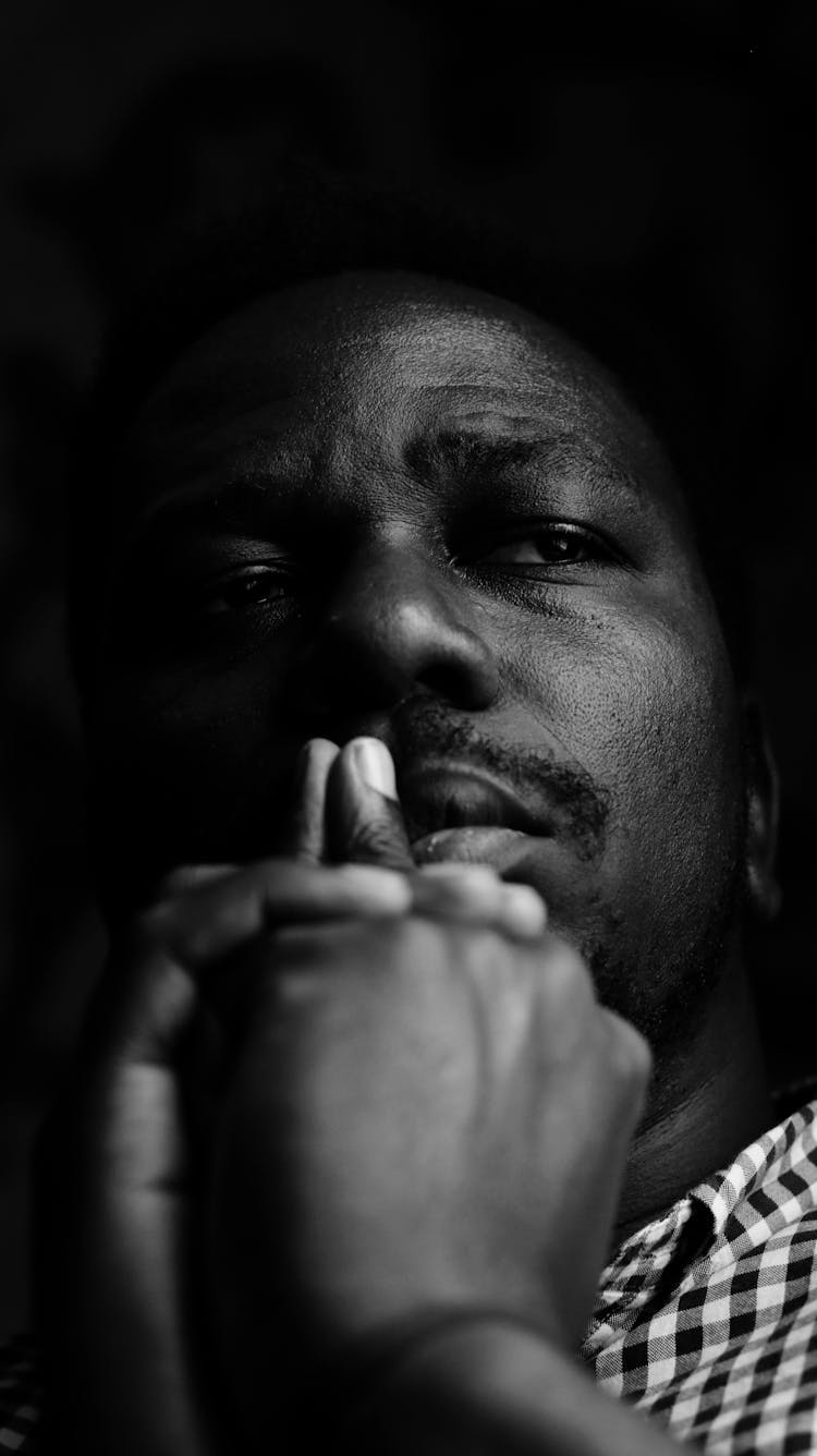 Sad Black Man Touching Lips And Thinking In Darkness